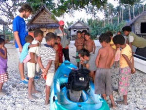 Reparando el kayak con la supervision de medio pueblo.